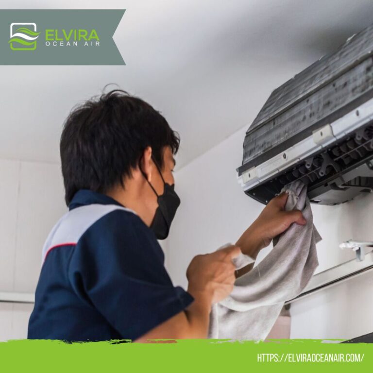 Technician cleaning a wall air conditioner filter