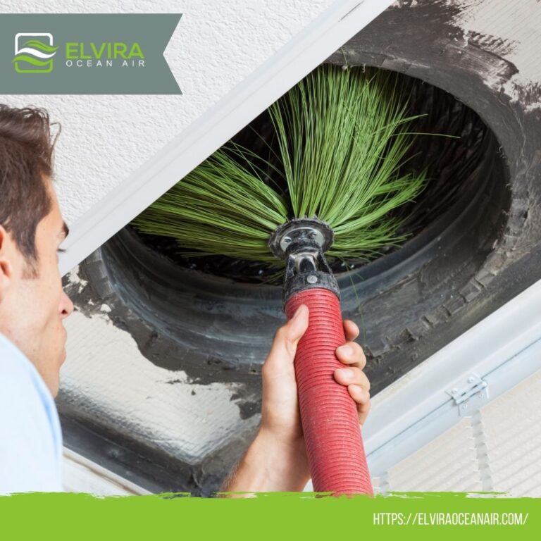Technician cleaning an air duct