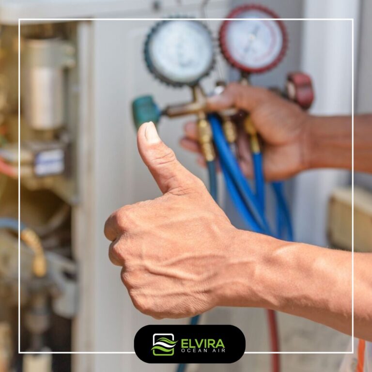 Technician giving a thumbs up next to refrigerant gauges
