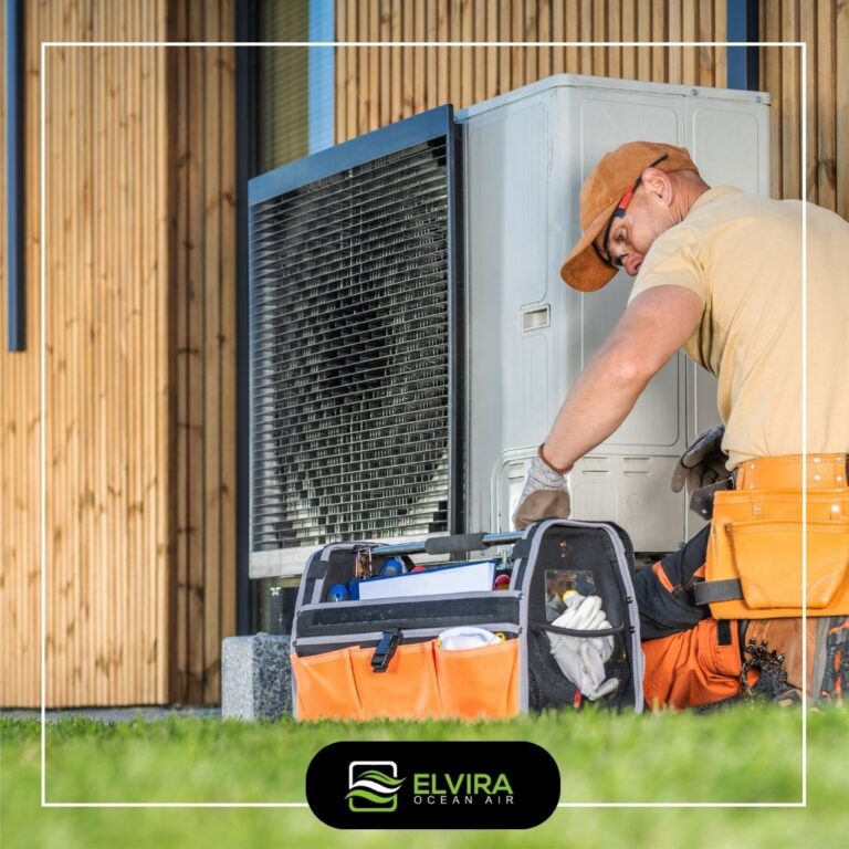 Technician servicing an outdoor heat pump beside a home