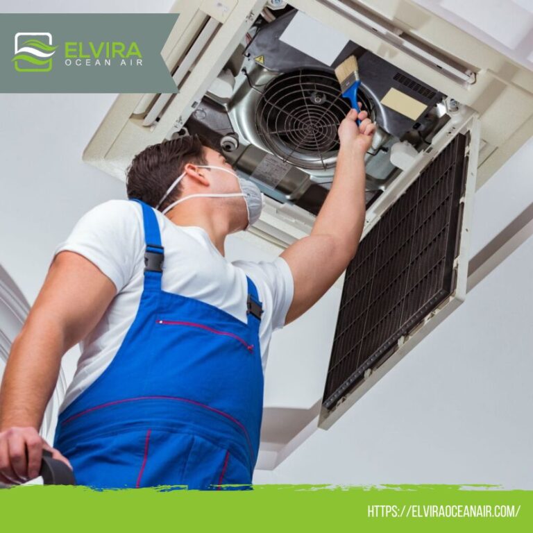 Technician cleaning a ceiling cassette air conditioner