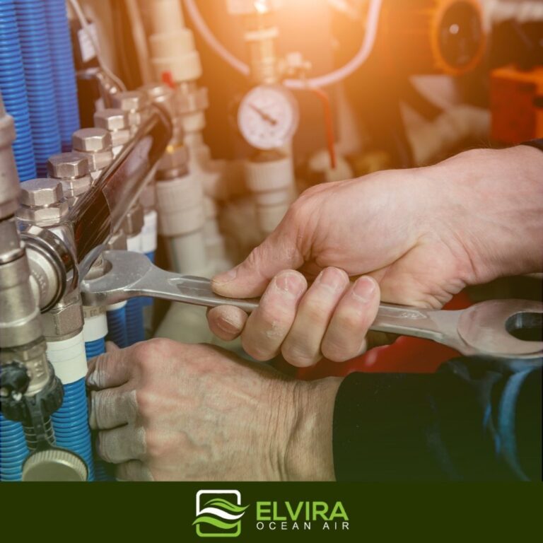 Technician tightening heating pipe fittings